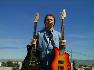 Alex Masi, acclaimed artist & Grammy nominee, is holding is an EXG-PRO and EXB-4PRO bass.